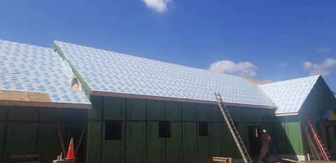 White ice-and-water shield membrane covering the roof of a building under construction