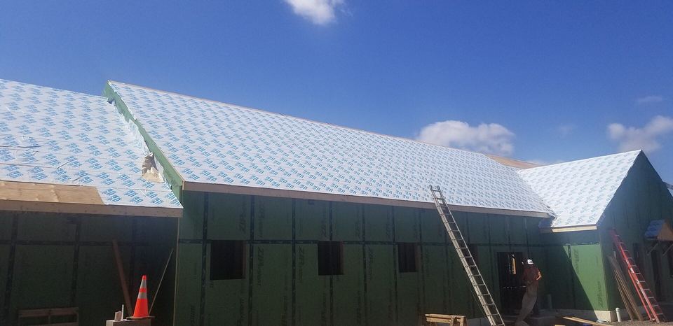 White ice-and-water shield membrane covering the roof of a building under construction